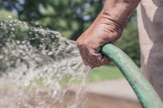 london man with garden hose